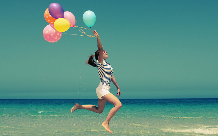 Abbildung: Frau mit Luftballons spring in die Luft